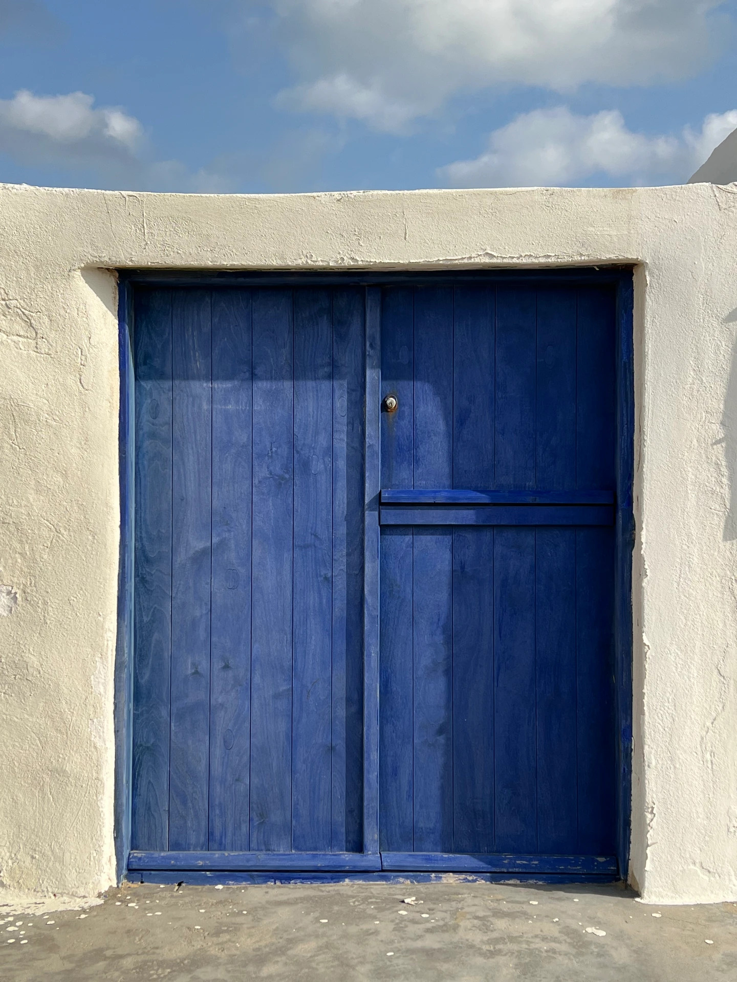 A blue door set in a white-washed wall, Ftelia, Mykonos