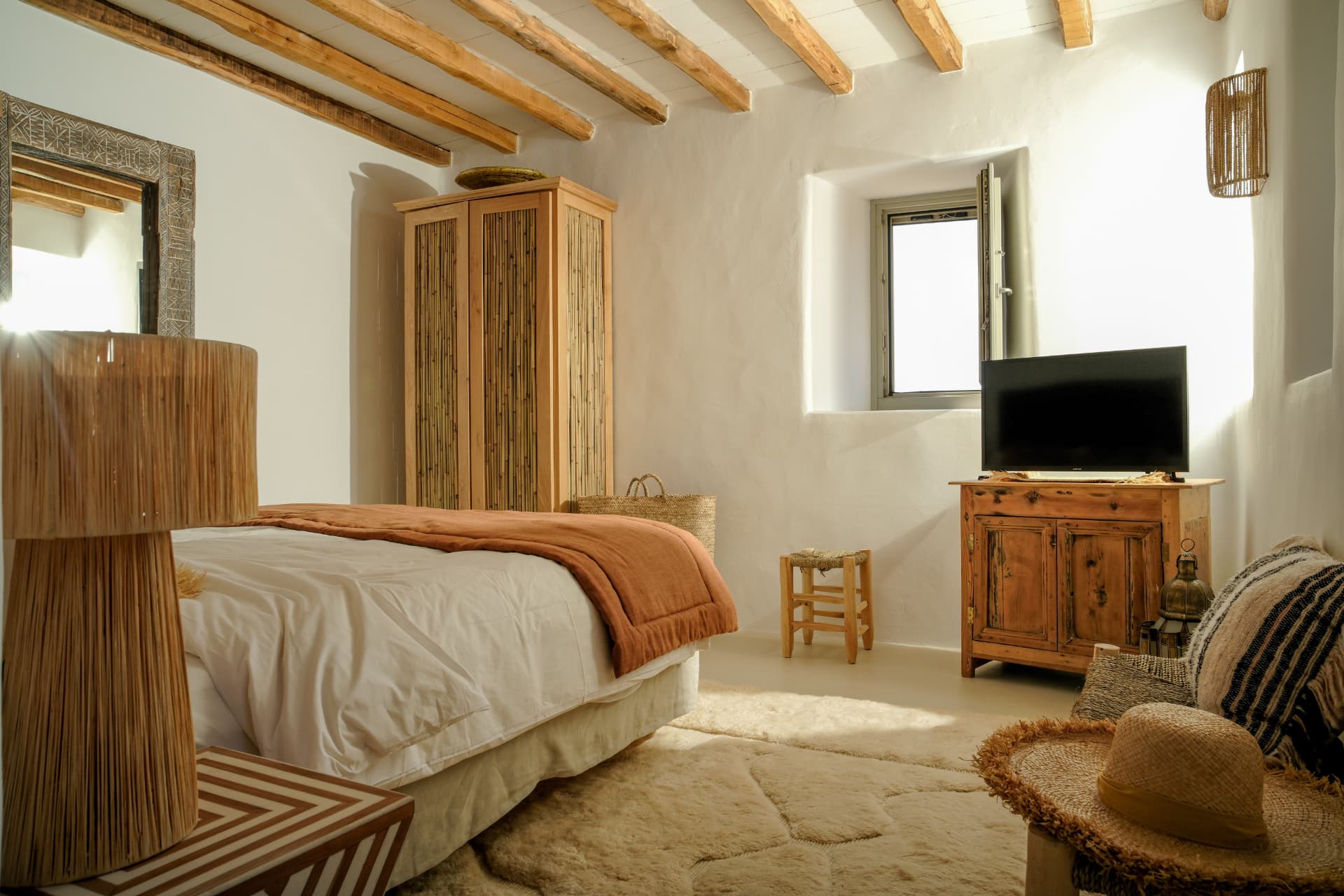The stone bedroom, bamboo-inlay wardrobe and natural light through the recessed window
