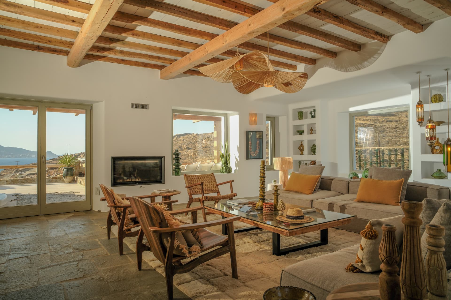 The Living room, L-shaped sofa and windows opening onto the sea