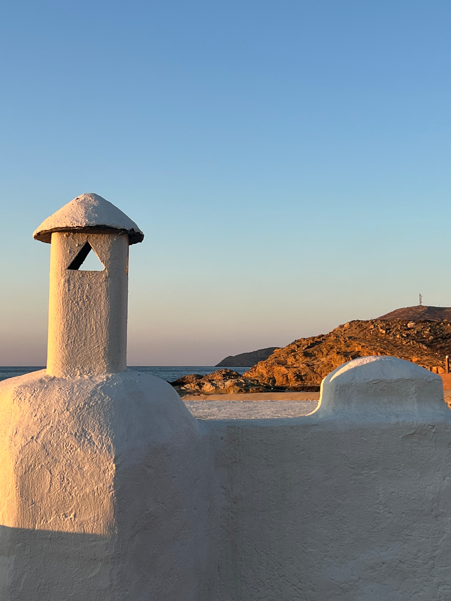 Cycladic chimney in golden light above the sea, Ftelia