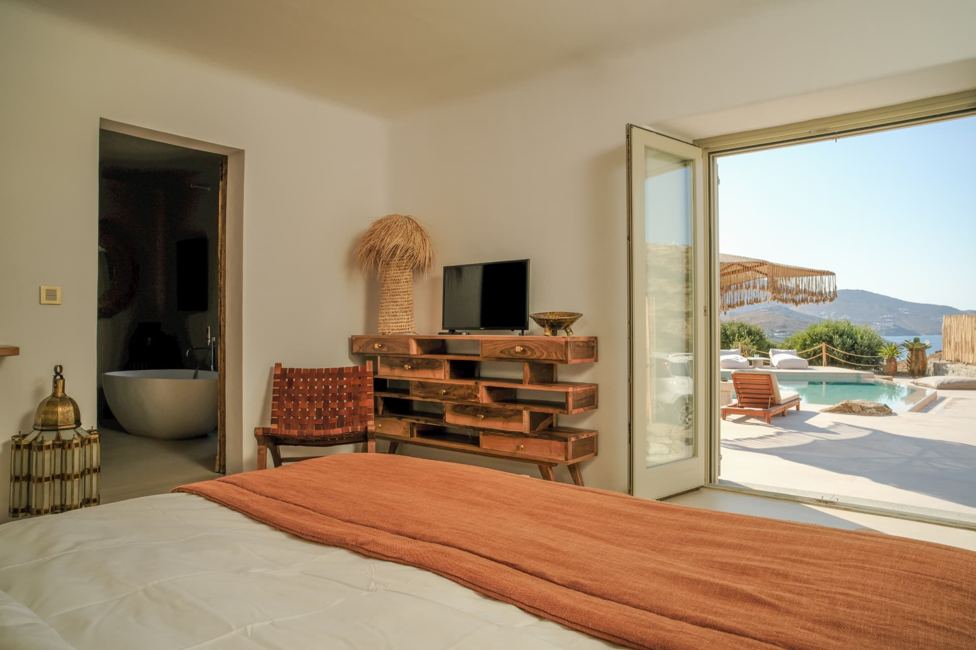 The Master Suite opening onto the pool and the sea beyond