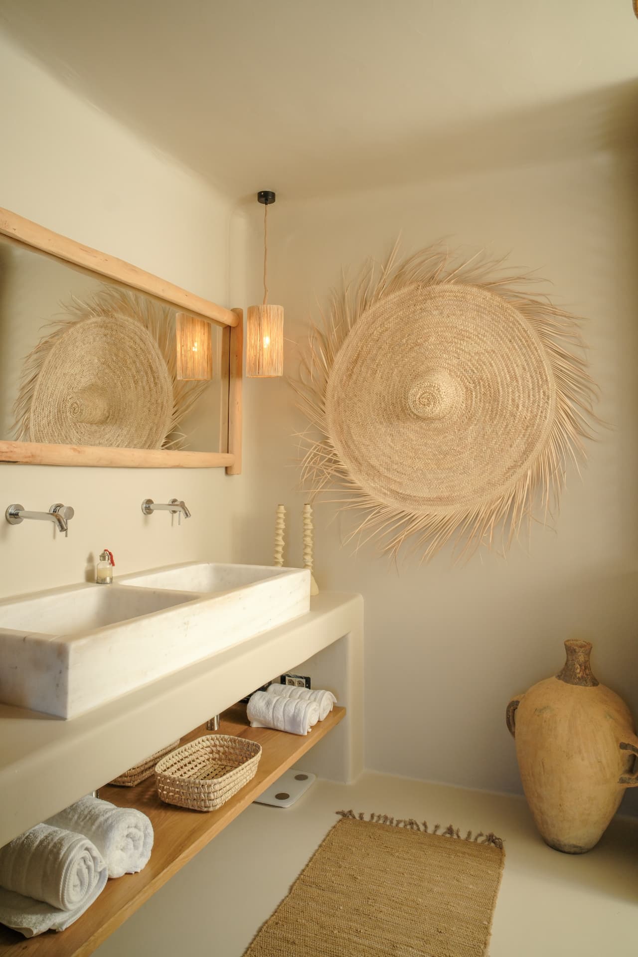 The Master Suite bathroom, double marble basins and woven wall hanging