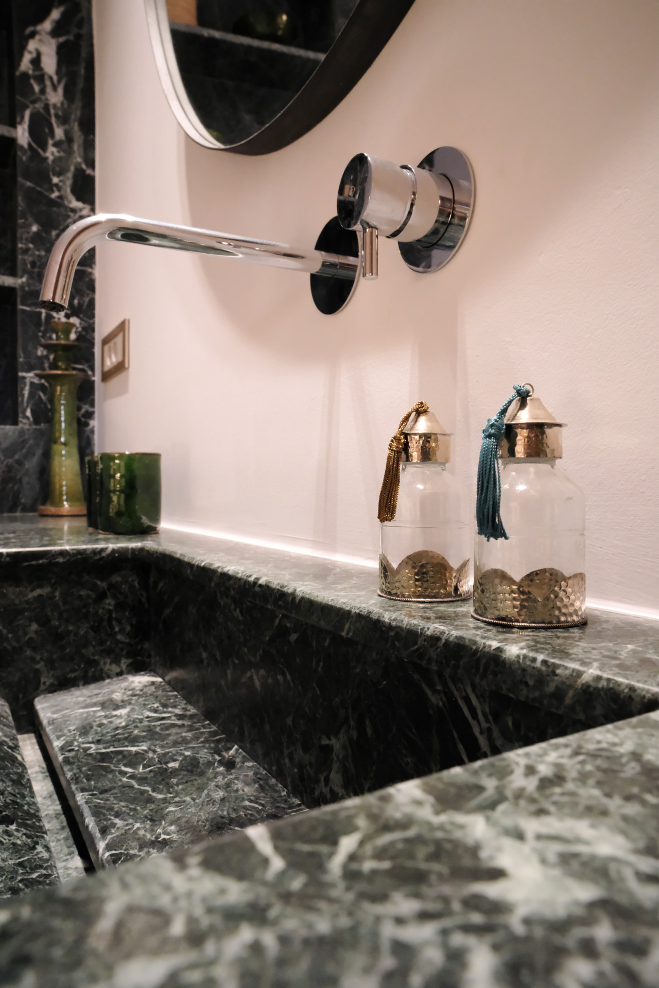 Detail, the marble basin, chrome tap and amber bottles of the Hammam Guest House