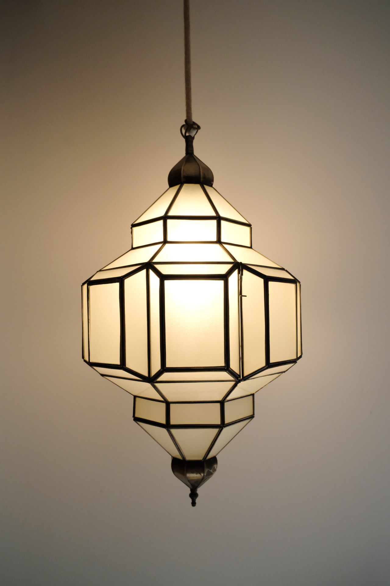 Detail, a geometric frosted-glass lantern on a rope cord in the Hammam Guest House