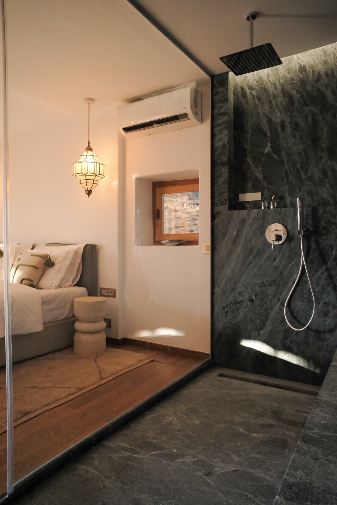 The Tinos-marble shower of the Hammam Guest House, seen toward the bedroom