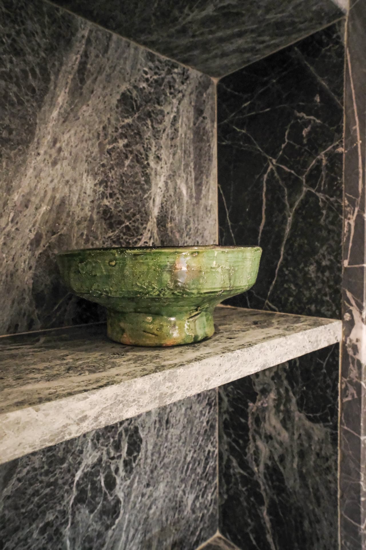 Detail, a green-glazed ceramic bowl on the marble shelf of the Hammam Guest House