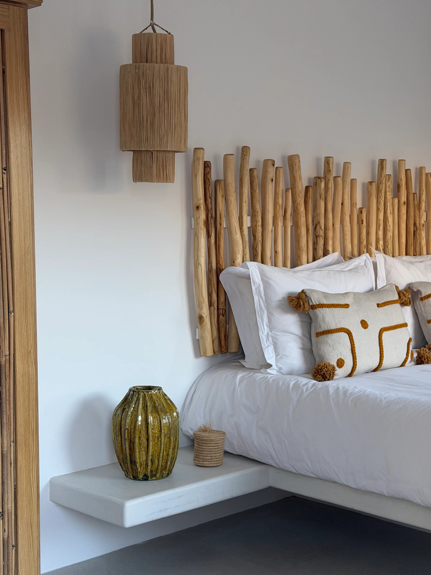 Detail, branch headboard, tiered pendant and olive-green vase in the Cycladic Suite