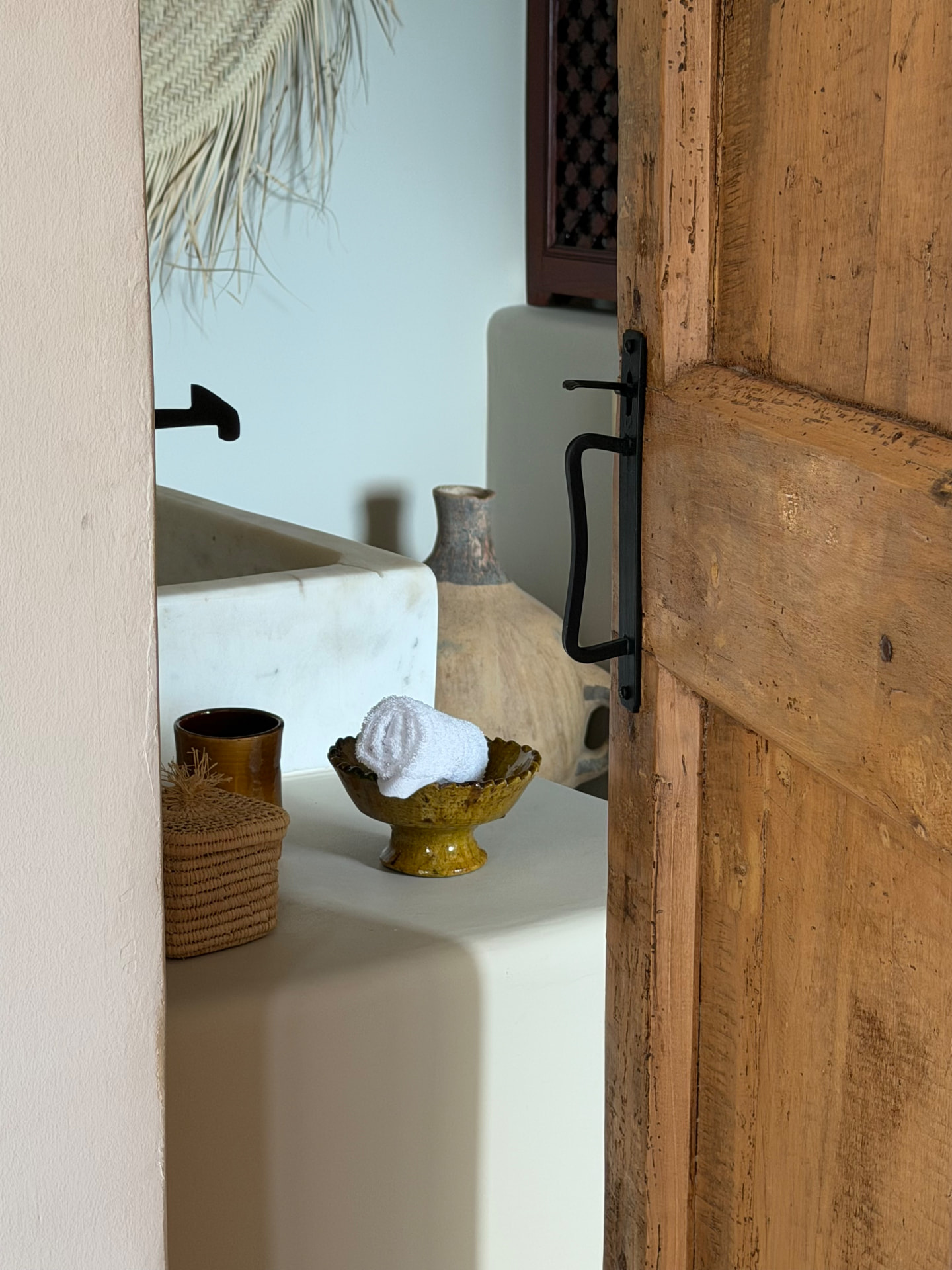 Antique wooden door opening onto the Master Suite bathroom