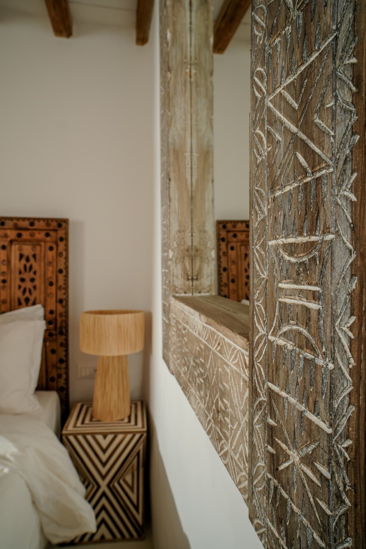 Detail, carved mirror frame and chevron side table in the Stone Shepherd's House