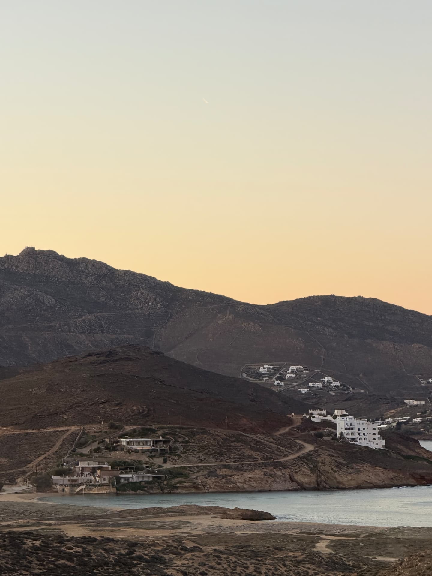 Bay and hillside houses at twilight, Ftelia, Mykonos