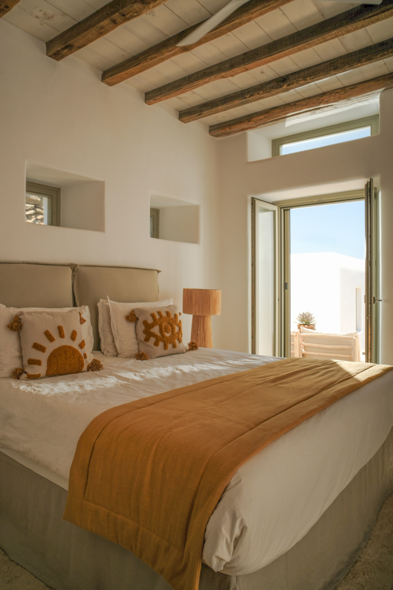 The Upper Suite bed, light across natural materials